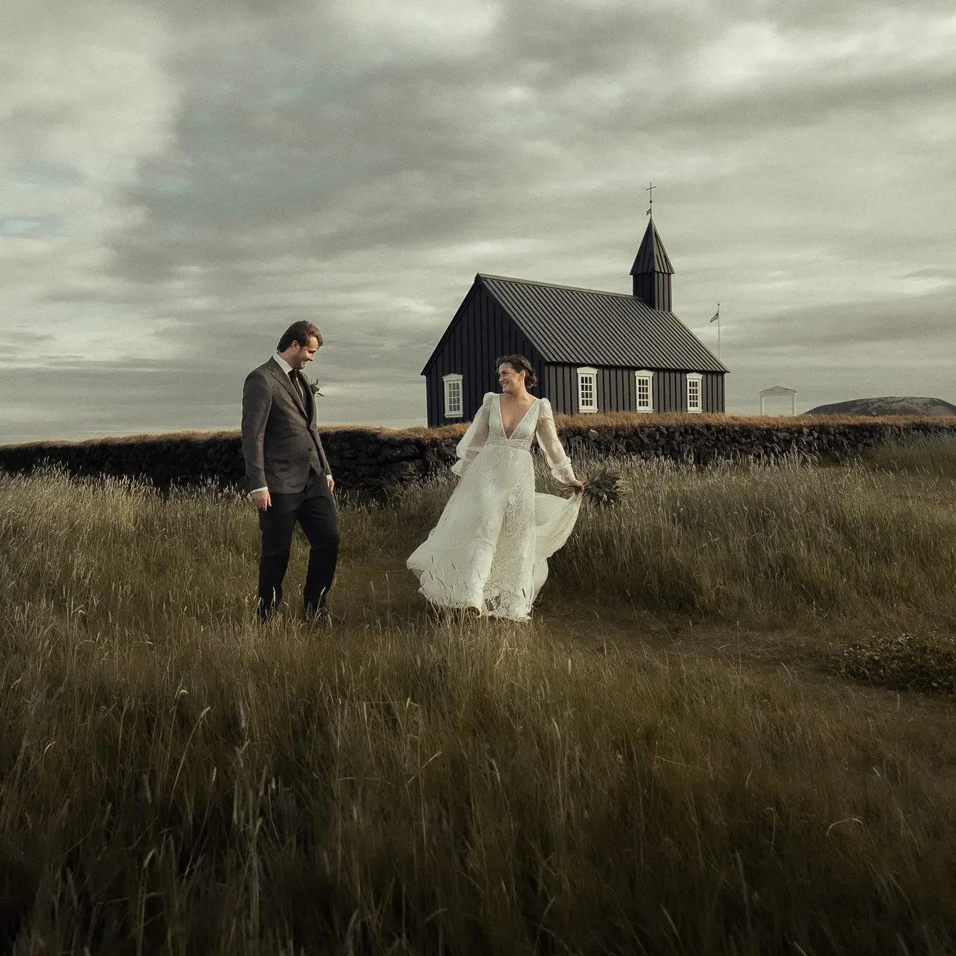 A bride and groom seeing each other for the first time during their elopement at Búðir Black Church in Iceland