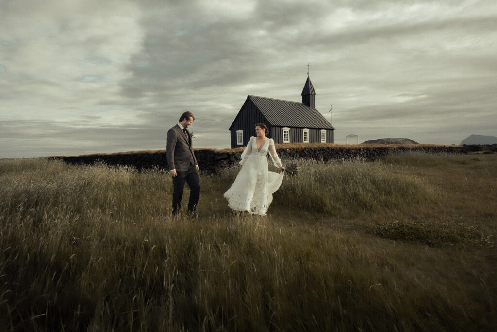 A bride and groom seeing each other for the first time during their elopement at Búðir Black Church in Iceland