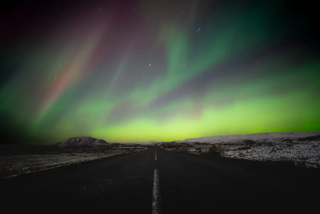 Northern lights over the road in Iceland