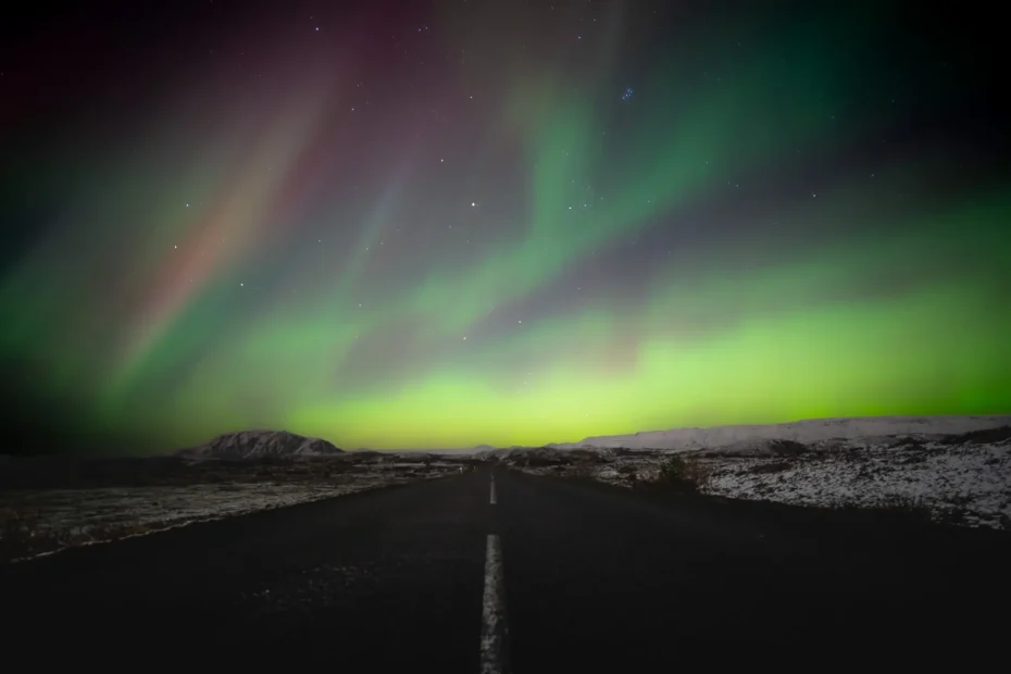 Northern lights over the road in Iceland