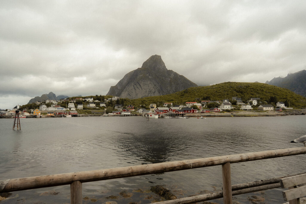 View from a cabin in Reine village with red rorbuer cabins and dramatic Lofoten mountains