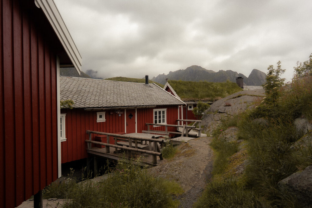 Red cabins in Reine village on the Lofoten Islands with mountains in the background