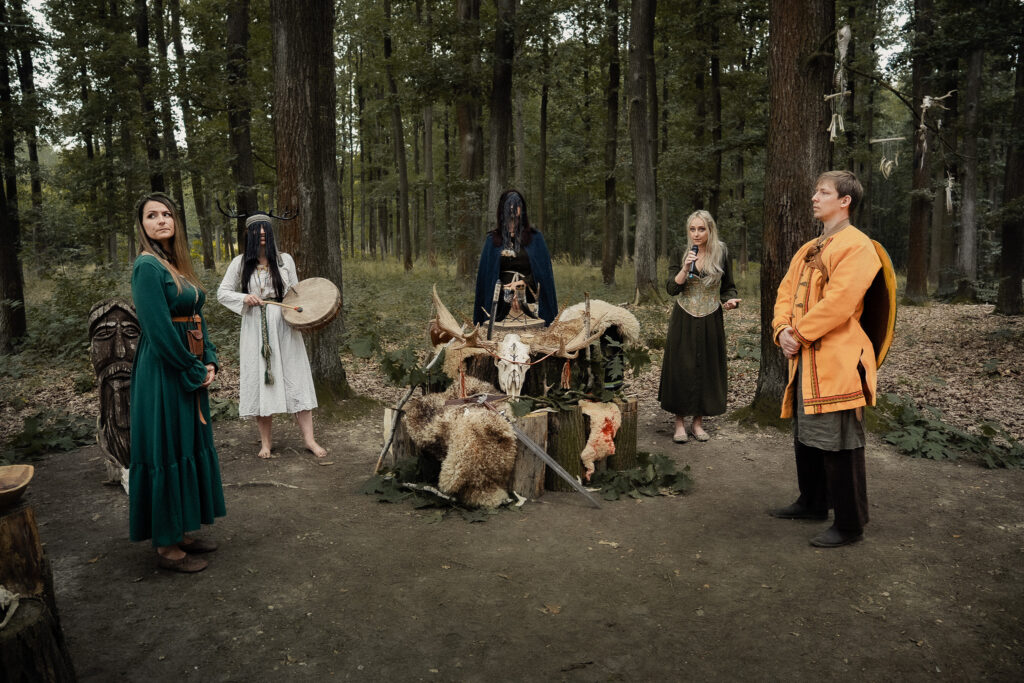 Pagan wedding ceremony in the forest with ritual altar and participants in traditional clothing