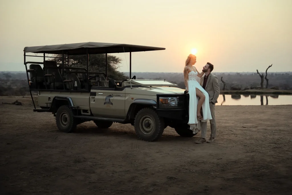 Bride and groom at sunset by a safari vehicle at Jabulani Safari Lodge in South Africa