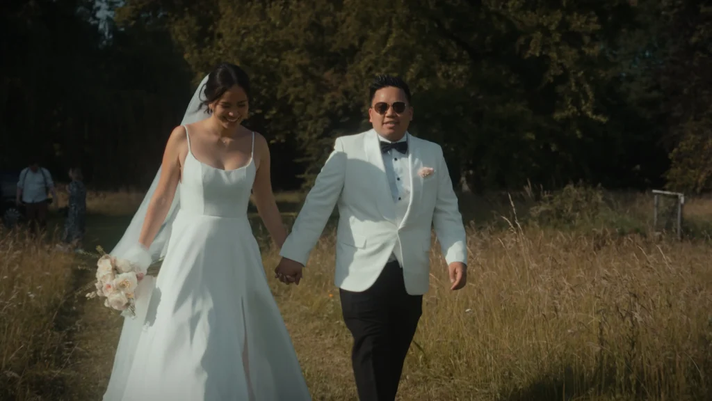 Bride and groom walking hand in hand at Schloss Fridau wedding venue in Austria