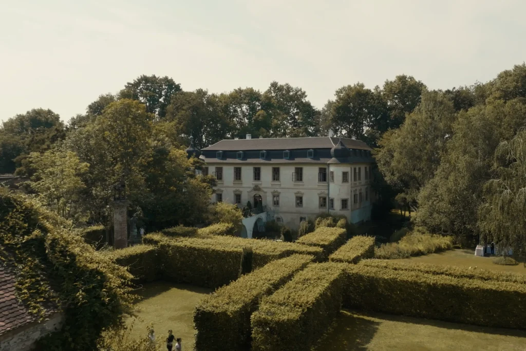 Aerial view of the château and garden in Třebešice surrounded by trees