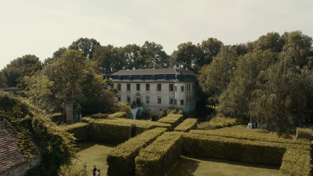 Aerial view of the château and garden in Třebešice surrounded by trees